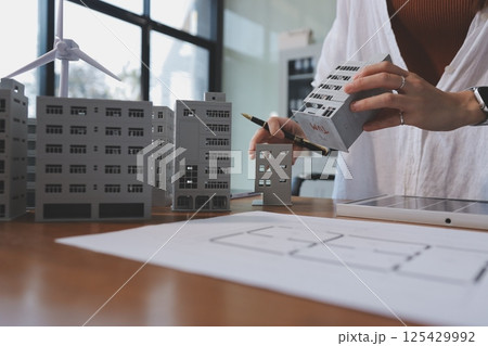 Discussion among businesspeople on the latest developments in solar cell panel technology and Solar Energy Environment city Concept. 125429992