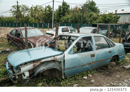 Abandoned broken down car on the street. Car dump and abandoned junk 125430373