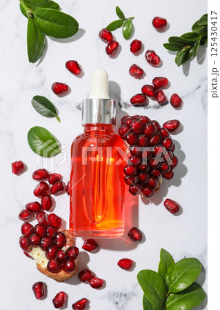 Self care and skincare products concept - pomegranate cosmetics Self care and skincare products concept - pomegranate cosmetics 125430417