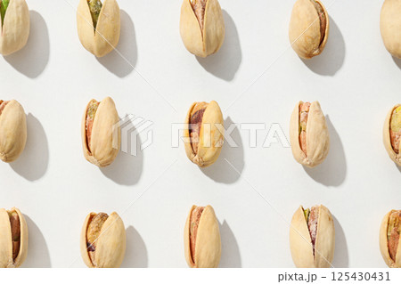 Pistachios in the shell, on a light background. Pistachios in the shell, on a light background. 125430431
