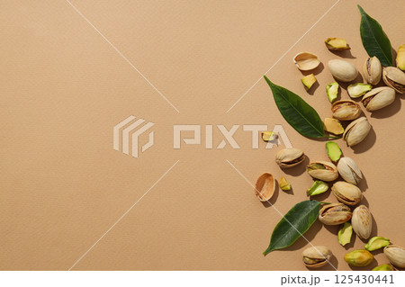 Pistachios in a plate, on a beige background. Pistachios in a plate, on a beige background. 125430441