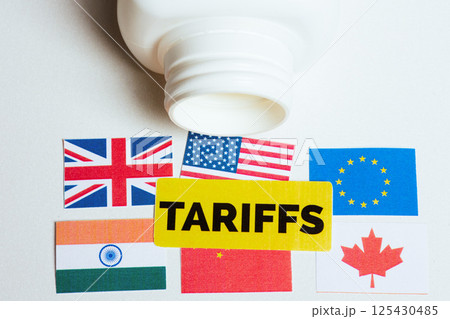 Global flags under TARIFFS label from medical bottle Global flags under TARIFFS label from medical bottle 125430485