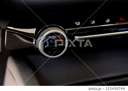 Climate control in a car. Temperature control buttons on a car air conditioner. 125430749