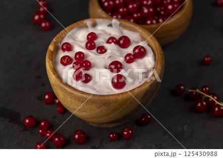 milk product made from milk with the addition of red sweet and sour currants and currant flavor, side view milk product made from milk with the addition of red sweet and sour currants and currant flavor, side view 125430988