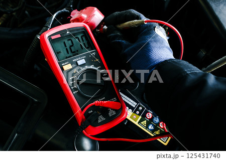 Car Battery Voltage Test displaying a reading of 12.70V DC Car Battery Voltage Test displaying a reading of 12.70V DC 125431740