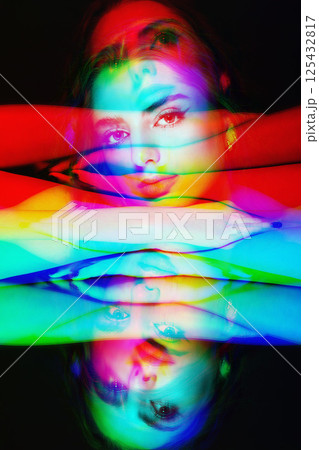 Woman placed head on hands and mirror reflection of model on glass surface in RGB color split effect style Woman placed head on hands and mirror reflection of model on glass surface in RGB color split effect style 125432817