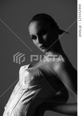 Beautiful woman dark silhouette studio portrait on gray background Beautiful woman dark silhouette studio portrait on gray background 125432994