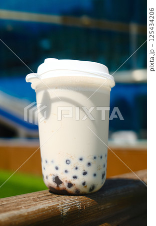 Milk bubble tea in plastic cup with blurred background 125434206