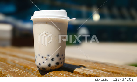 Milk bubble tea in plastic cup with blurred background 125434208