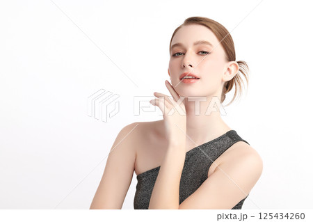 A beautiful young woman with clean, fresh skin against a white background. Skincare, facial treatment, cosmetology, beauty, and spa. An elegant portrait of an woman. A beautiful young woman with clean, fresh skin against a white background. Skincare, facial treatment, cosmetology, beauty, and spa. An elegant portrait of an woman. 125434260