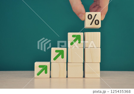 Businessman stacking wooden blocks into growing char Businessman stacking wooden blocks into growing char 125435368