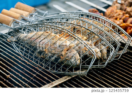 Fish Grilling In Metal Basket 125435759