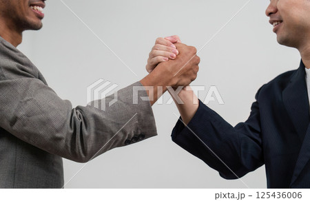 Handshake and Collaboration. Two professionals engaging in a handshake, symbolizing partnership and agreement. 125436006