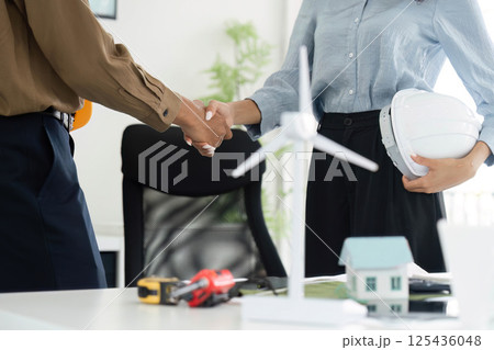 Professional Engagement and Sustainability. Handshake between professionals on a sustainable project. Professional Engagement and Sustainability. Handshake between professionals on a sustainable project. 125436048