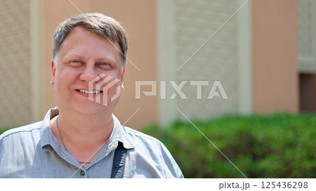 Adult man with open kind smile, close-up portrait 125436298