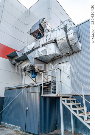 Large insulated ventilation ducts and industrial fans attached to a metal building wall, concept of air circulation system 125436436