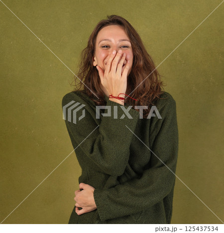 Joyful Woman in Olive Green Sweater Joyful Woman in Olive Green Sweater 125437534