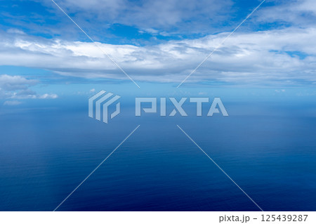 Aerial view of the Pacific Ocean with clouds and deep blue water 125439287
