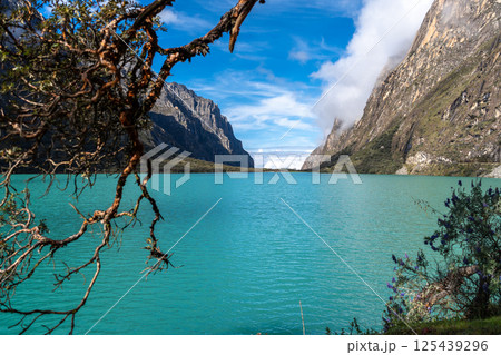 Turquoise lake surrounded by mountains on the Laguna 69 trek, Peru 125439296