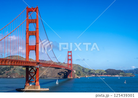 Golden Gate Bridge over blue waters with scenic hills in San Francisco Golden Gate Bridge over blue waters with scenic hills in San Francisco 125439301