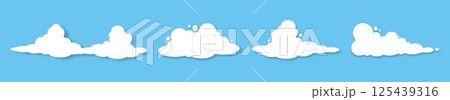 A set of icons of white fluffy clouds with a shadow on a blue background. 125439316