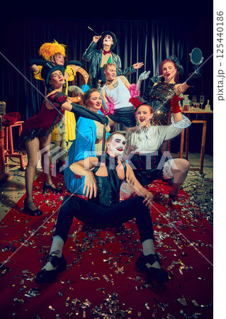 Group cabaret performers striking dramatic pose on confetti-covered red carpet Group cabaret performers striking dramatic pose on confetti-covered red carpet 125440186