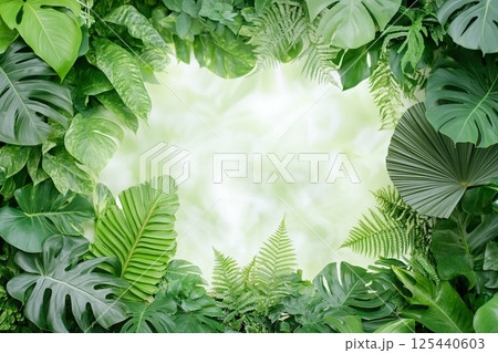 Lush greenery with tropical leaves forming natural frame and copy space. Lush greenery with tropical leaves forming natural frame and copy space. 125440603