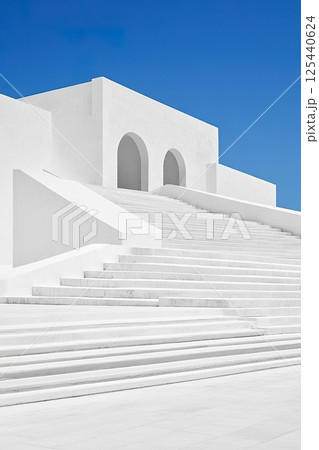 Minimalist white modern architecture against clear blue sky. 125440624