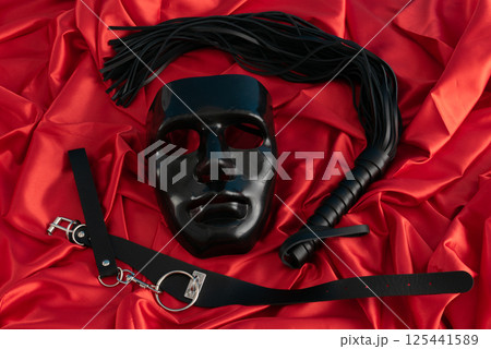 Adult sex games. Kinky lifestyle. Spank on the red linen. Bdsm outfit 125441589
