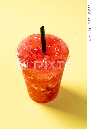 Red strawberry slushieon yellow background Red strawberry slushieon yellow background 125441959