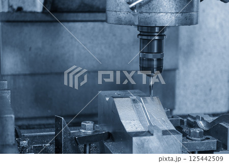 The CNC milling machine cutting  mold part by solid ball nose end mill tool in the light blue scene. 125442509