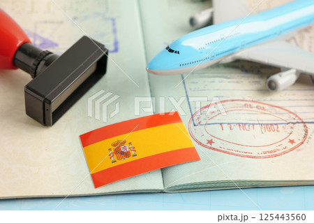 Spain passport with approved stamp on document for tourism. Spain passport with approved stamp on document for tourism. 125443560