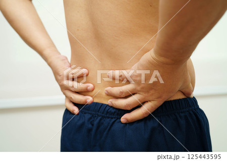 Asian man pain back muscle, spine and bone from accident. Asian man pain back muscle, spine and bone from accident. 125443595
