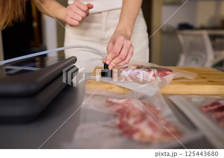 Sealing Fresh Meat for Preservation Using a Vacuum Sealer for Longer Lasting Freshness 125443680