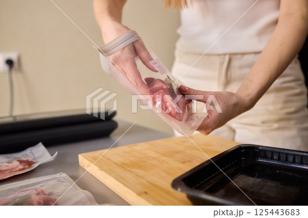 Sealing Fresh Meat for Preservation Using a Vacuum Sealer for Longer Lasting Freshness 125443683