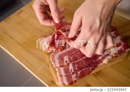 Artisan Style Meat Preparation on a Beautifully Crafted Wooden Board for Serving Artisan Style Meat Preparation on a Beautifully Crafted Wooden Board for Serving 125443947