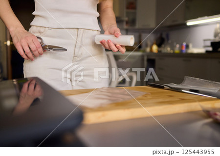 Hands Skillfully Preparing Vacuum Sealing for Food Preservation and Storage Purposes Hands Skillfully Preparing Vacuum Sealing for Food Preservation and Storage Purposes 125443955