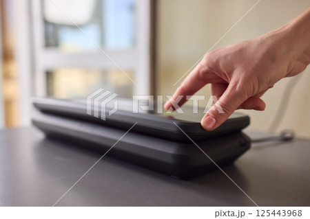 A person interacting with a touchscreen device to enhance their overall engagement and experience A person interacting with a touchscreen device to enhance their overall engagement and experience 125443968