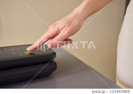 A person interacting with a touchscreen device to enhance their overall engagement and experience 125443969