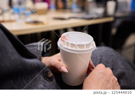 Cozy Moment A Hand Gently Holding a Warm Cup Filled with Delicious and Aromatic Coffee Brew Cozy Moment A Hand Gently Holding a Warm Cup Filled with Delicious and Aromatic Coffee Brew 125444010