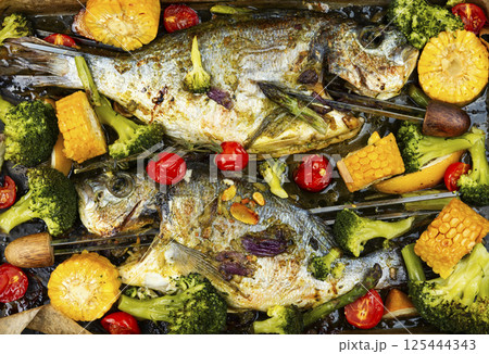 Fried dorado fish, seafood shashlik. 125444343