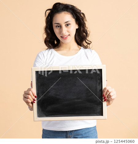 Woman studio portrait with blackboard Woman studio portrait with blackboard 125445060