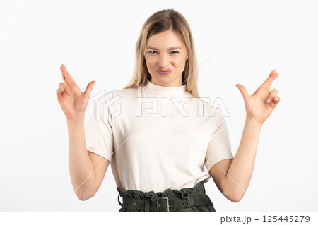 Smiling woman with crossed fingers Smiling woman with crossed fingers 125445279