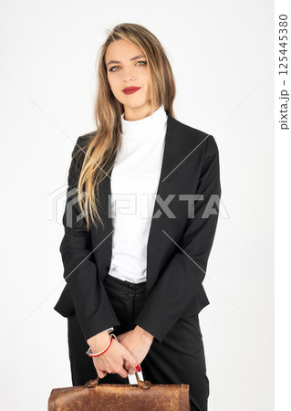 Business woman with black suit and brown suitcase 125445380