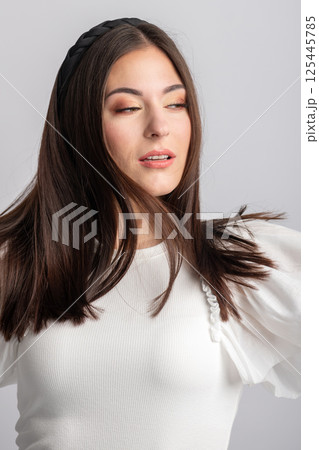 Close-up beautiful woman with long dark hair and headband portrait Close-up beautiful woman with long dark hair and headband portrait 125445785