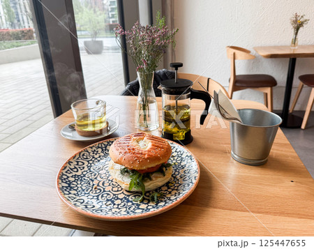 Bagel with sesame bun and arugula. Cafe breakfast culture, natural flavors and urban dining experiences 125447655