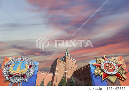 Moscow Kremlin (with orders of victory)--Victory Day celebration (WWII), Russia-- the most popular view. Against the sky with clouds. English translation from Russian: USSR, Victory, Patriotic war 125447853