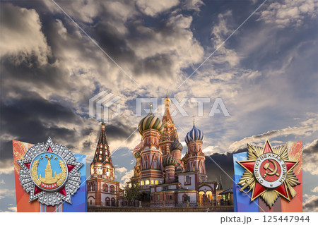Temple of Basil the Blessed with orders of victory in honor of Victory Day celebration (WWII), Red Square, Moscow, Russia. Against the clouds 125447944