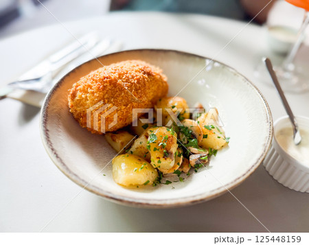 Kiev style chicken cutlet served with mashed potatoes and mushrooms Kiev style chicken cutlet served with mashed potatoes and mushrooms 125448159