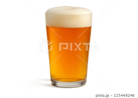 Craft Beer Served in a Clear Glass With Frothy Head Sitting on a Table During a Sunny Afternoon 125449246